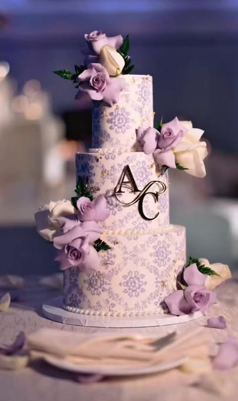 A three-tier lavender damask wedding cake with sugar roses by Twinkle Cakes by Sudha
